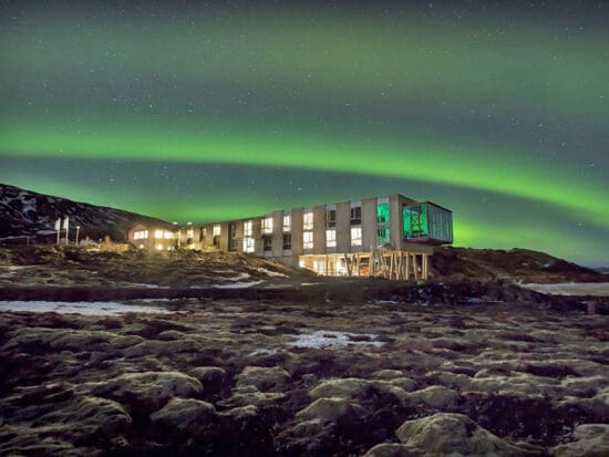 a building with green lights in the sky