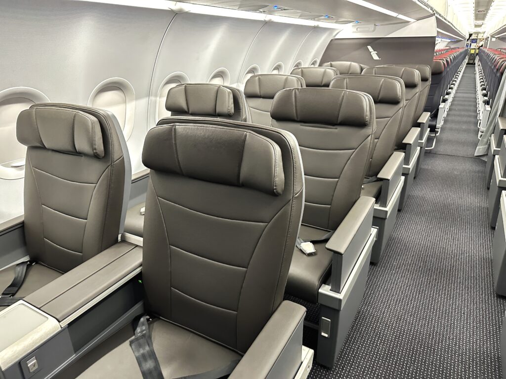 The interior of an American Airlines A321 showing the first class cabin to which Alaska Airlines Mileage Plan elite members can receive a complimentary upgrade