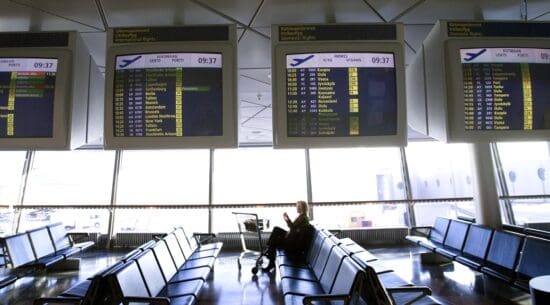 a person sitting on a bench in an airport