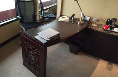 a desk with a lamp and a telephone on it