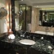 a bathroom with a marble countertop and a large mirror