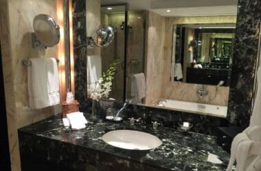 a bathroom with a marble countertop and a large mirror