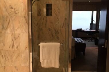 a bathroom with a glass shower door and a sink