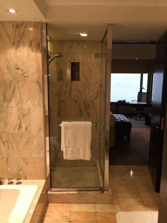 a bathroom with a glass shower door and a sink