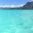 a body of water with a mountain in the background