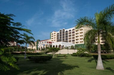 a large building with many windows and a lawn