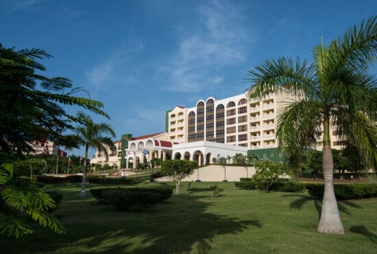 a large building with many windows and a lawn