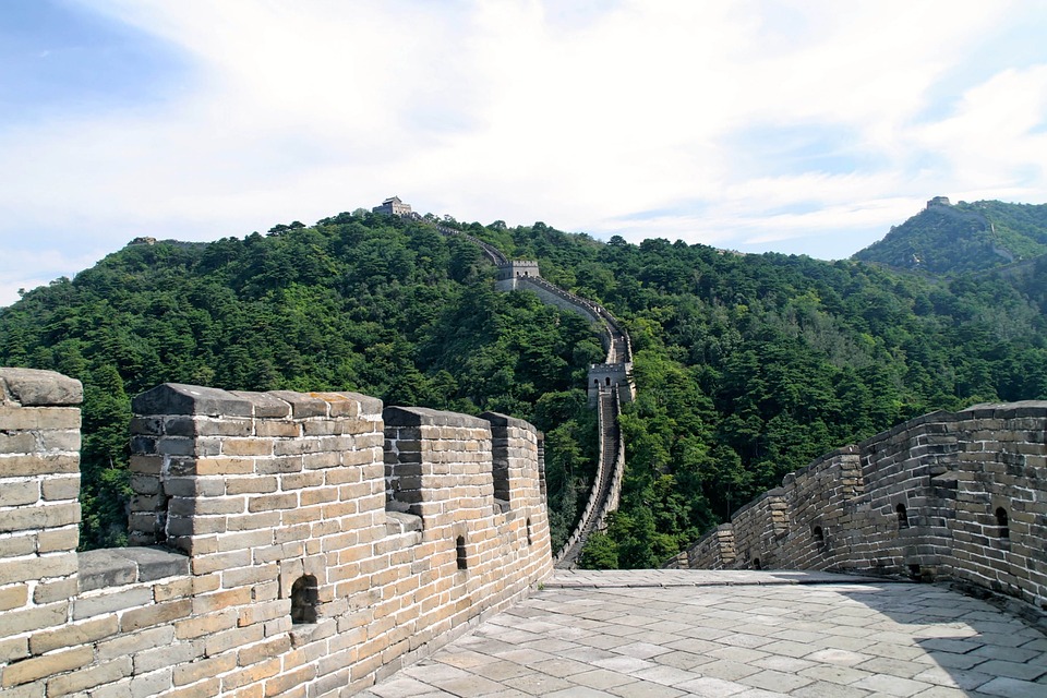 a long wall with trees in the background