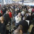 a large crowd of people in an airport