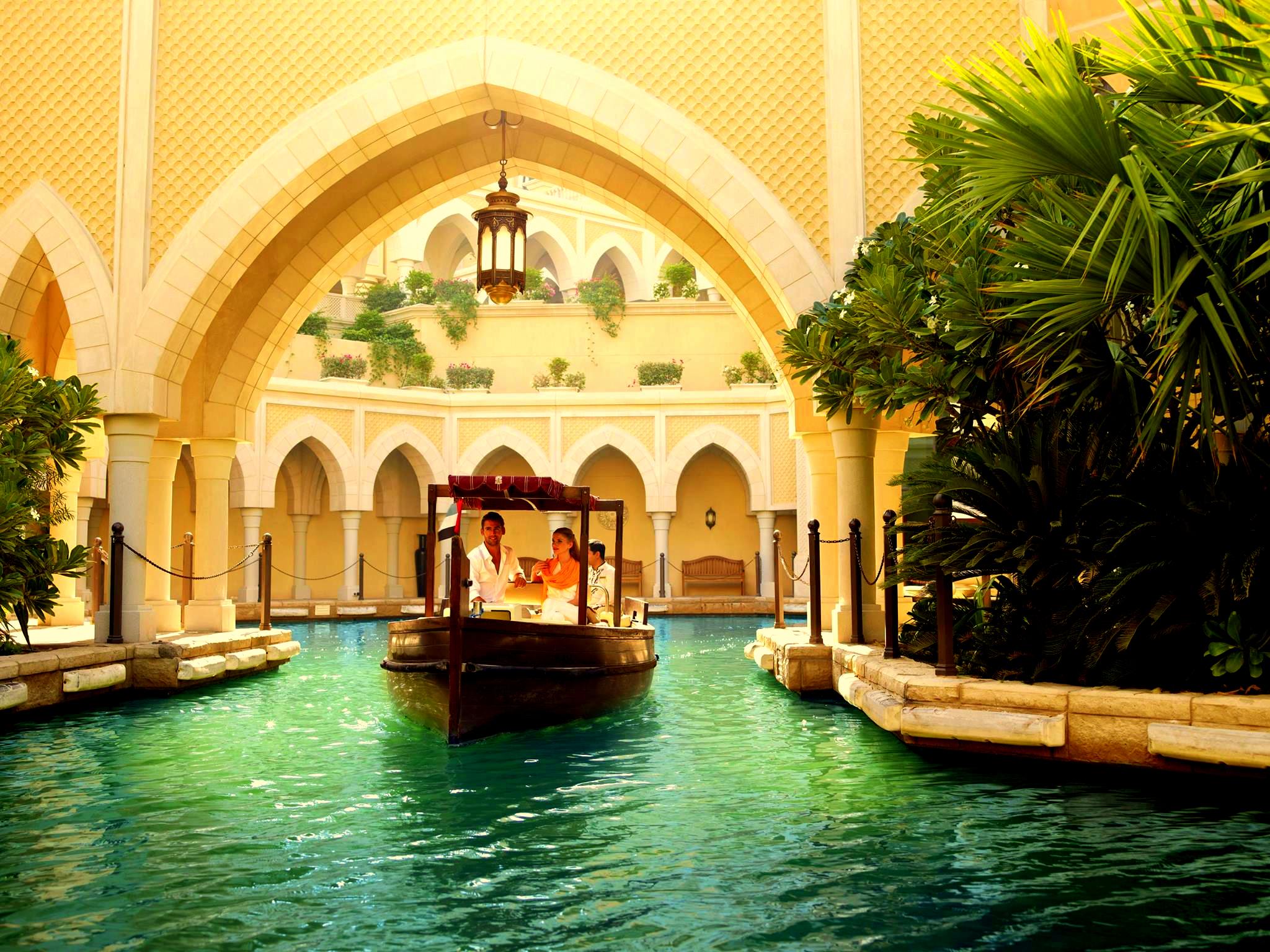 a boat in a river under a archway