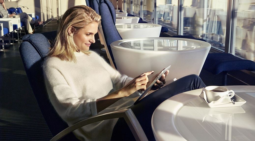 a woman sitting in a chair using a tablet