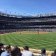 a baseball stadium with people watching a baseball game