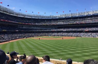 a baseball stadium with people watching a baseball game