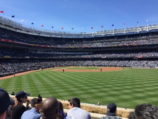 a baseball stadium with people watching a baseball game