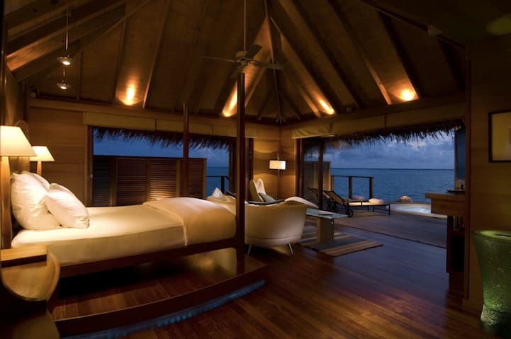 a room with a bed and a ceiling fan