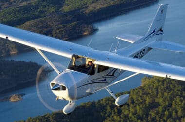 a small airplane flying over water