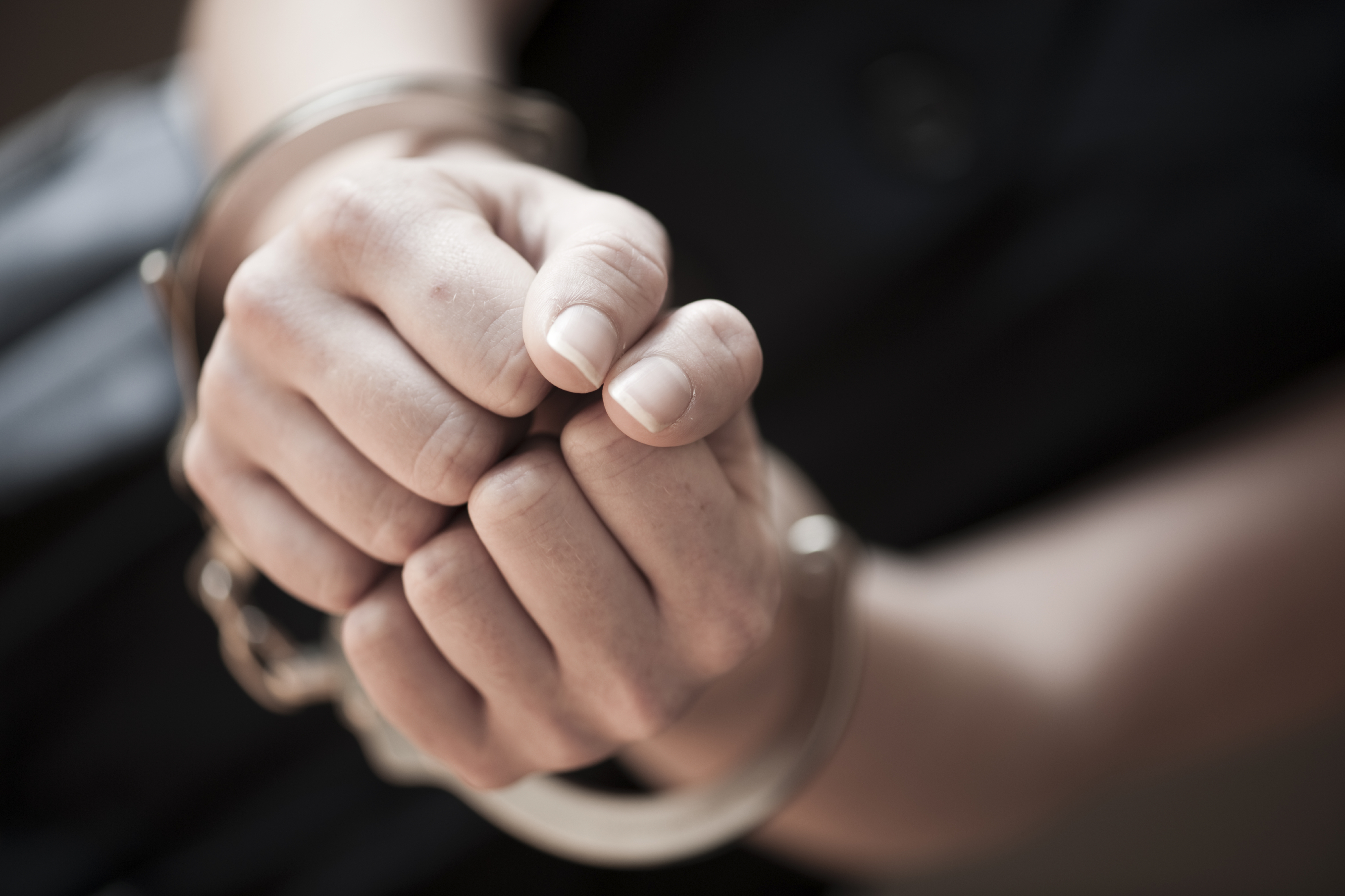 a close-up of a hand in handcuffs