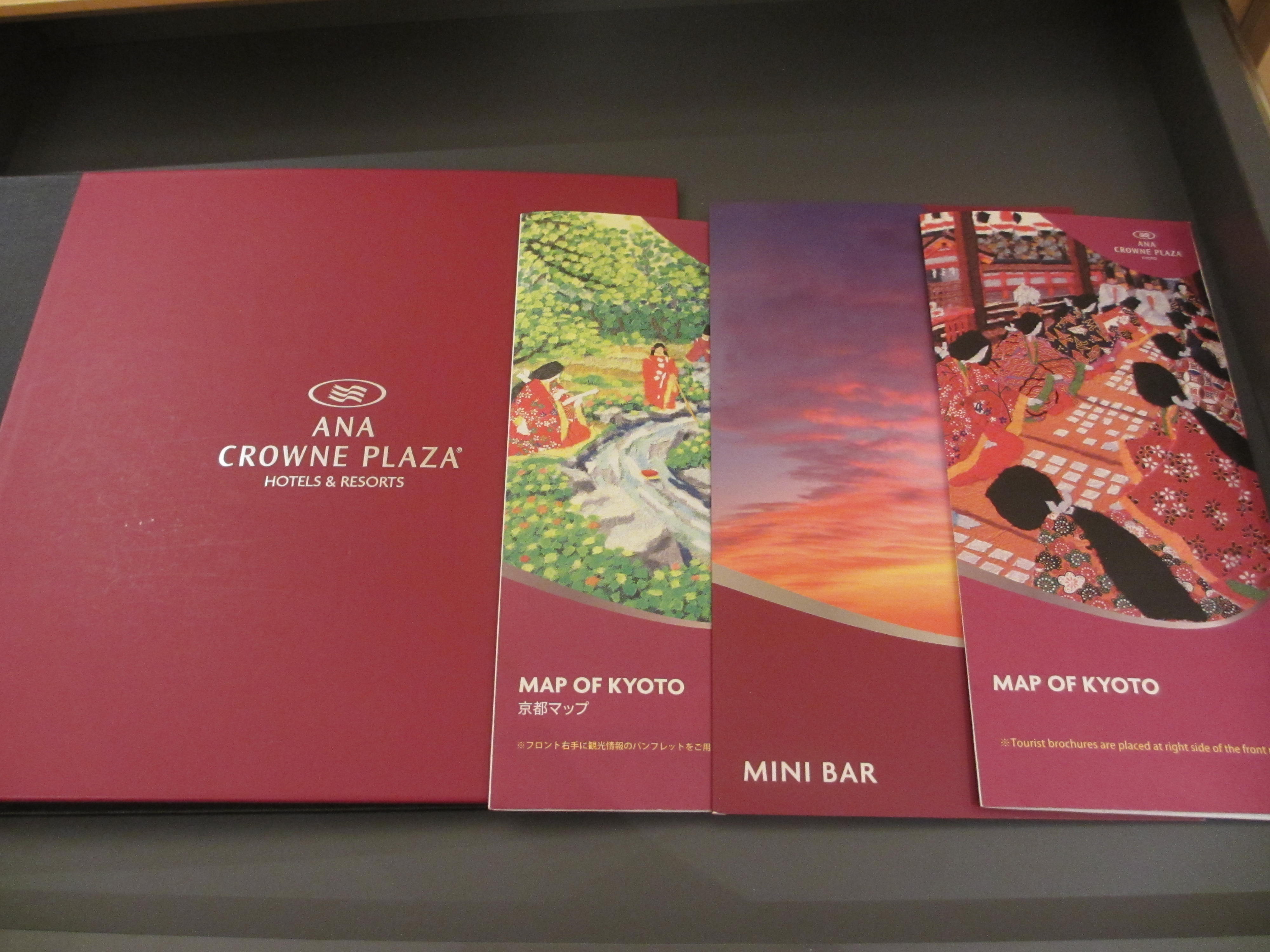 a group of red folders with images of people and map of kyoto