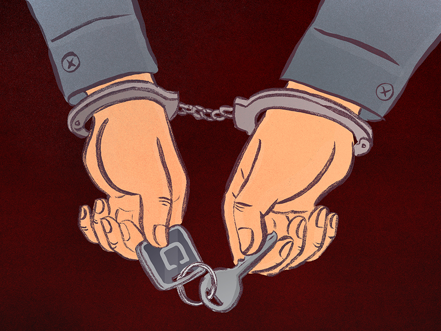 a pair of hands in handcuffs holding a key