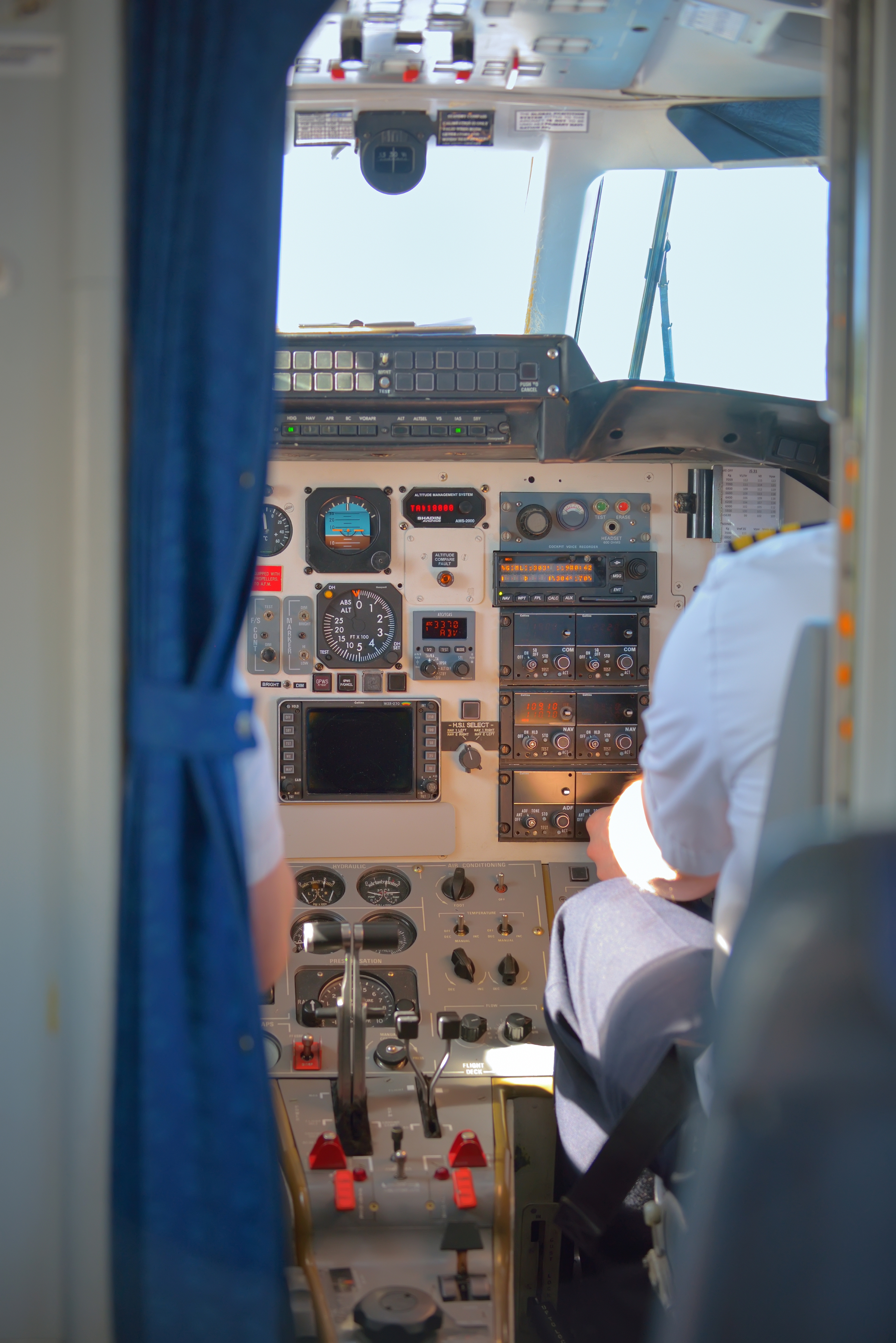 a cockpit of an airplane with a man in the cockpit