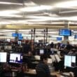 people working at computers in a large room