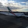 a group of airplanes parked at an airport