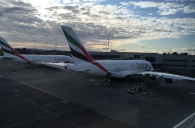 a group of airplanes parked at an airport