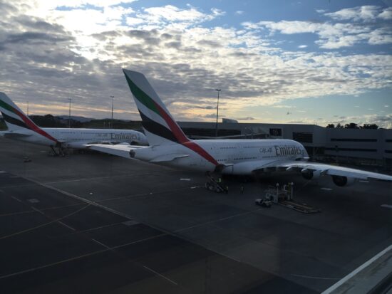 a group of airplanes parked at an airport