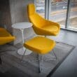 a yellow chair and a white table