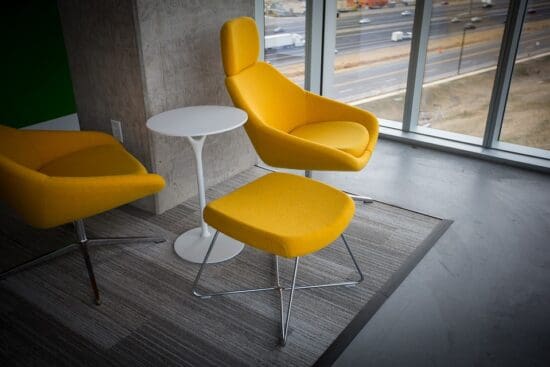 a yellow chair and a white table