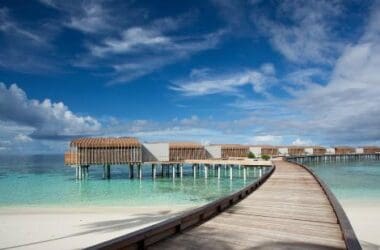 a long wooden walkway leading to a beach