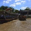 a group of boats on a river with Mekong in the background