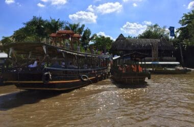 a group of boats on a river with Mekong in the background