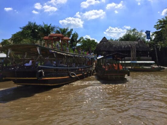 a group of boats on a river with Mekong in the background