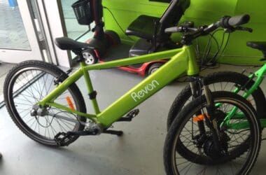 a green bicycle next to a green wall