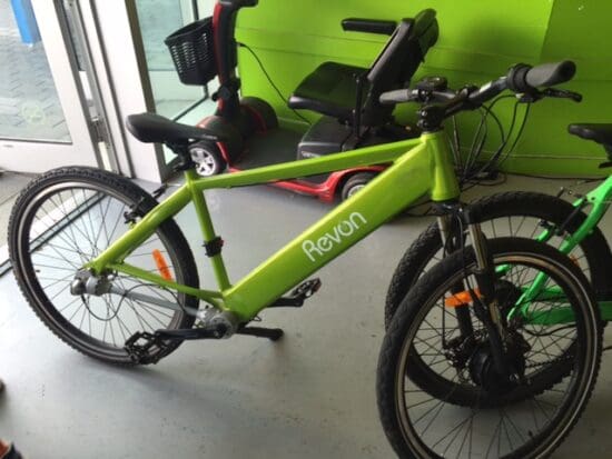 a green bicycle next to a green wall