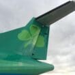 the tail of a plane with a shamrock on it