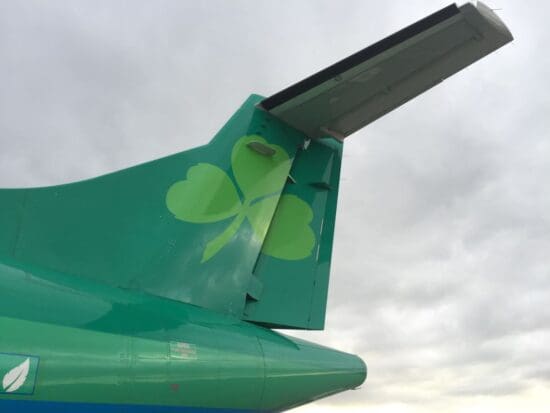 the tail of a plane with a shamrock on it