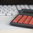 a calculator next to a keyboard