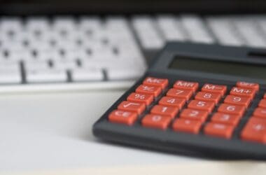 a calculator next to a keyboard