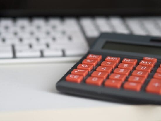 a calculator next to a keyboard