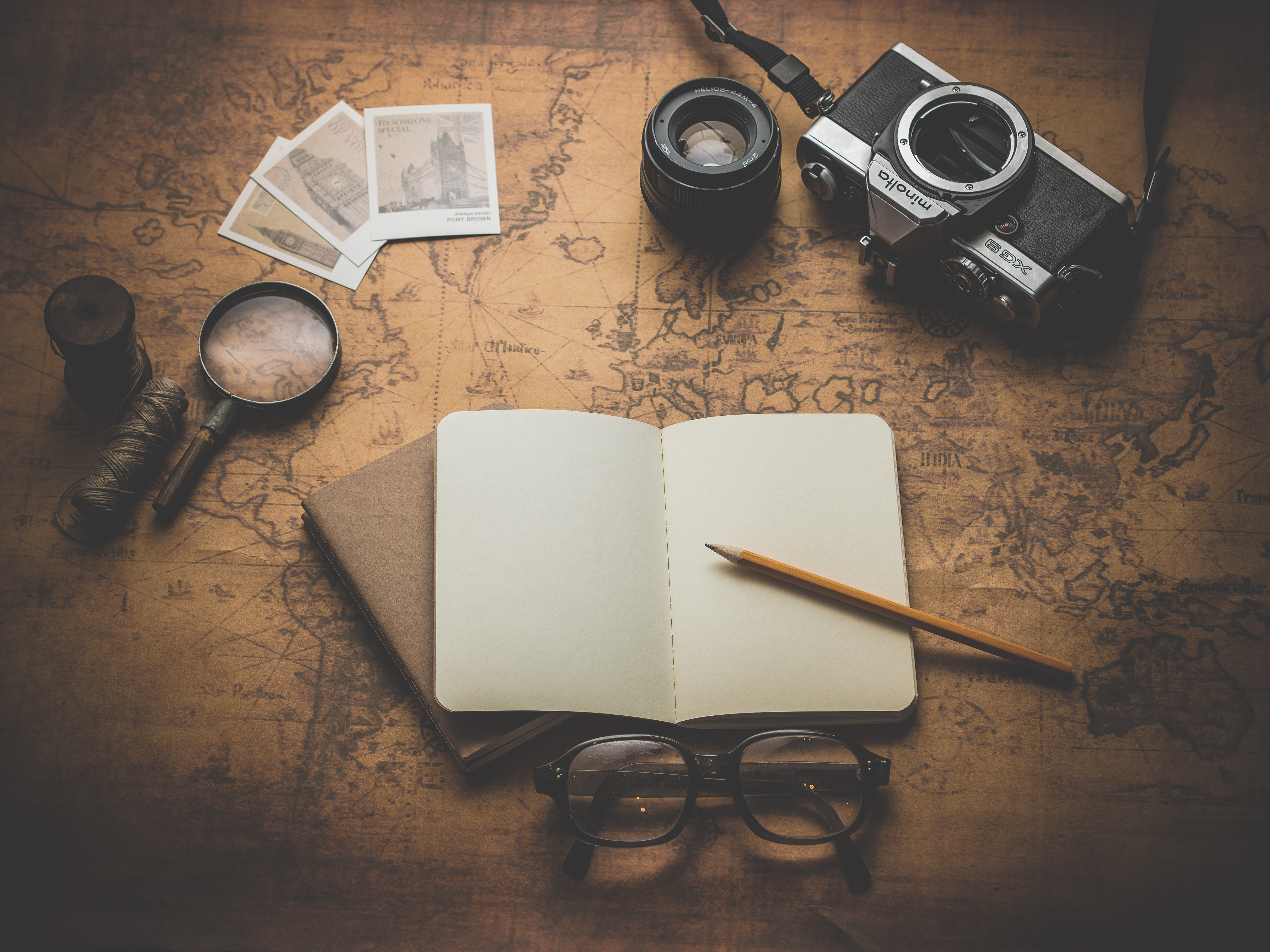 a notebook and camera on a map