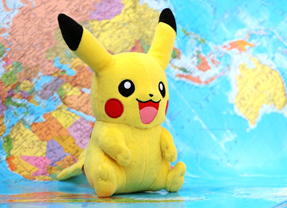 a yellow stuffed animal on a world map