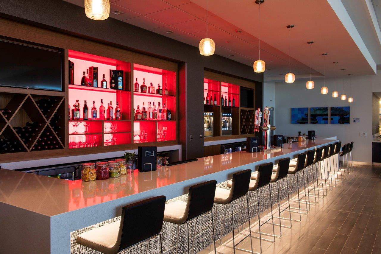 a bar with a counter and chairs