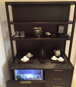 a shelf with a small refrigerator