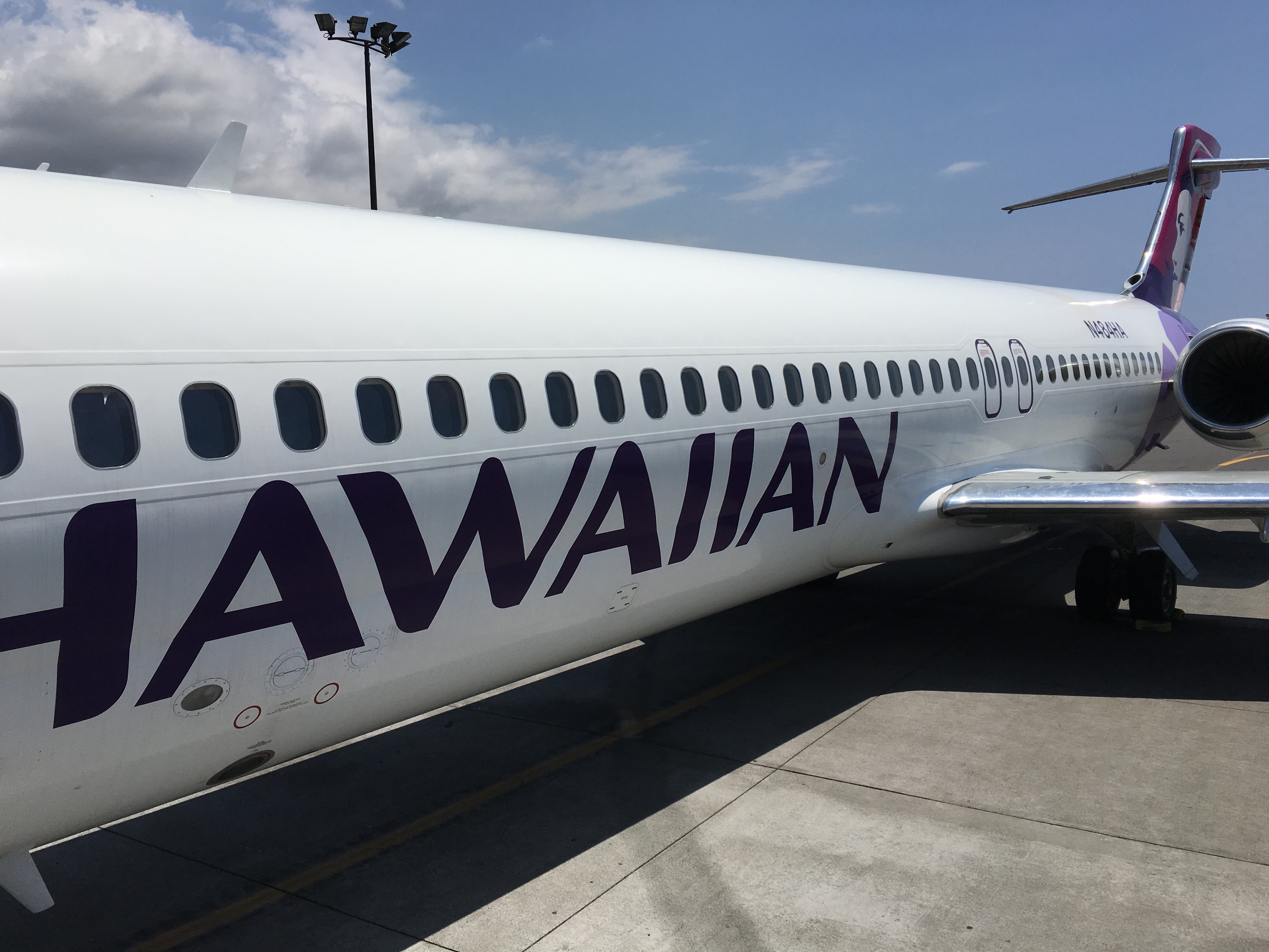 a white airplane with purple writing on it