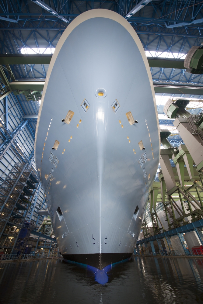 a large white boat in a factory