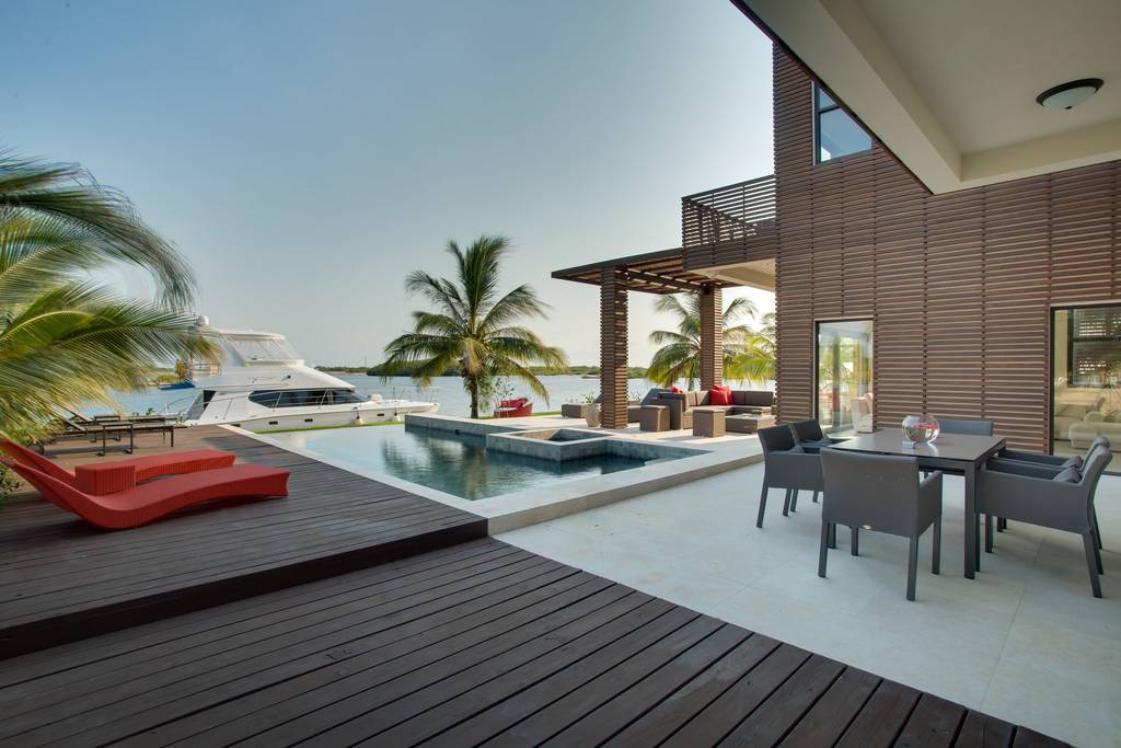 a deck with a pool and a table