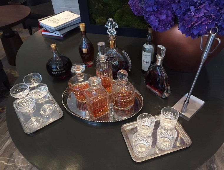 a table with glasses and bottles of liquor