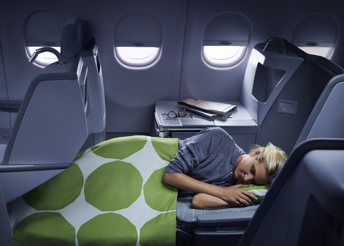 a woman sleeping in an airplane